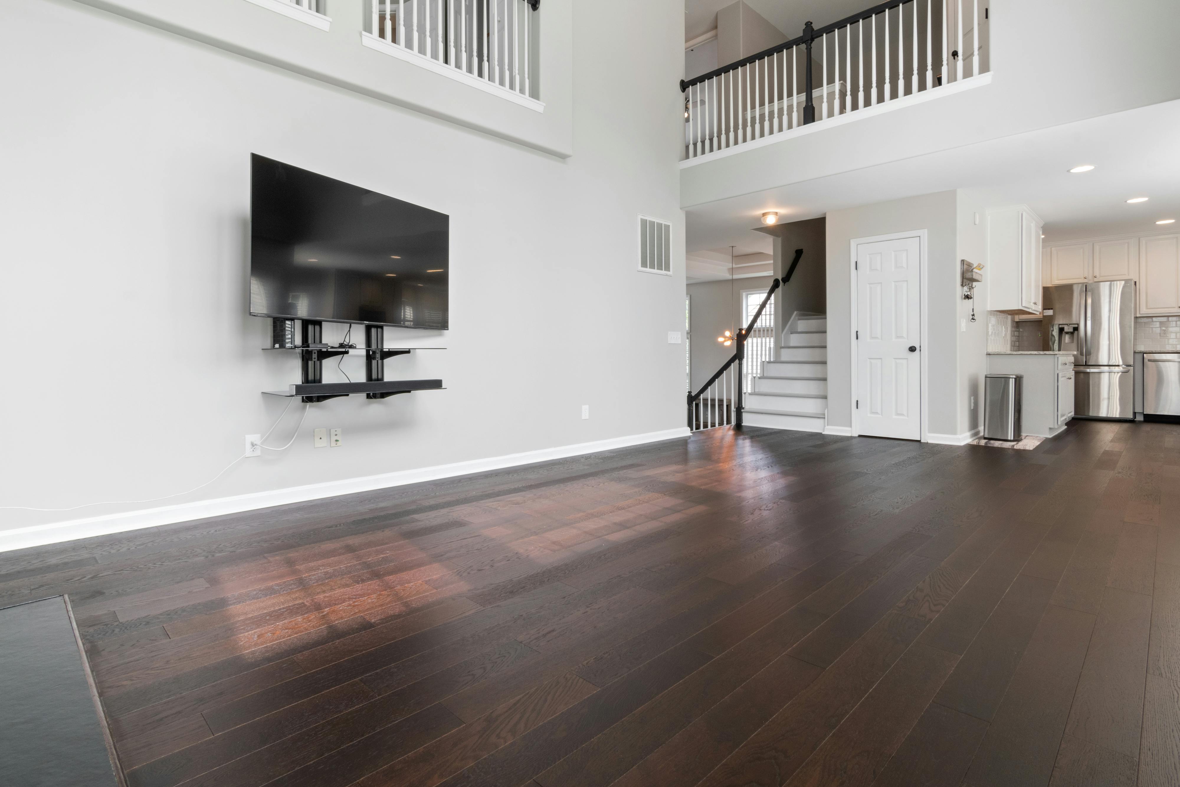 Dark wide plank engineered hardwood in two-story living room