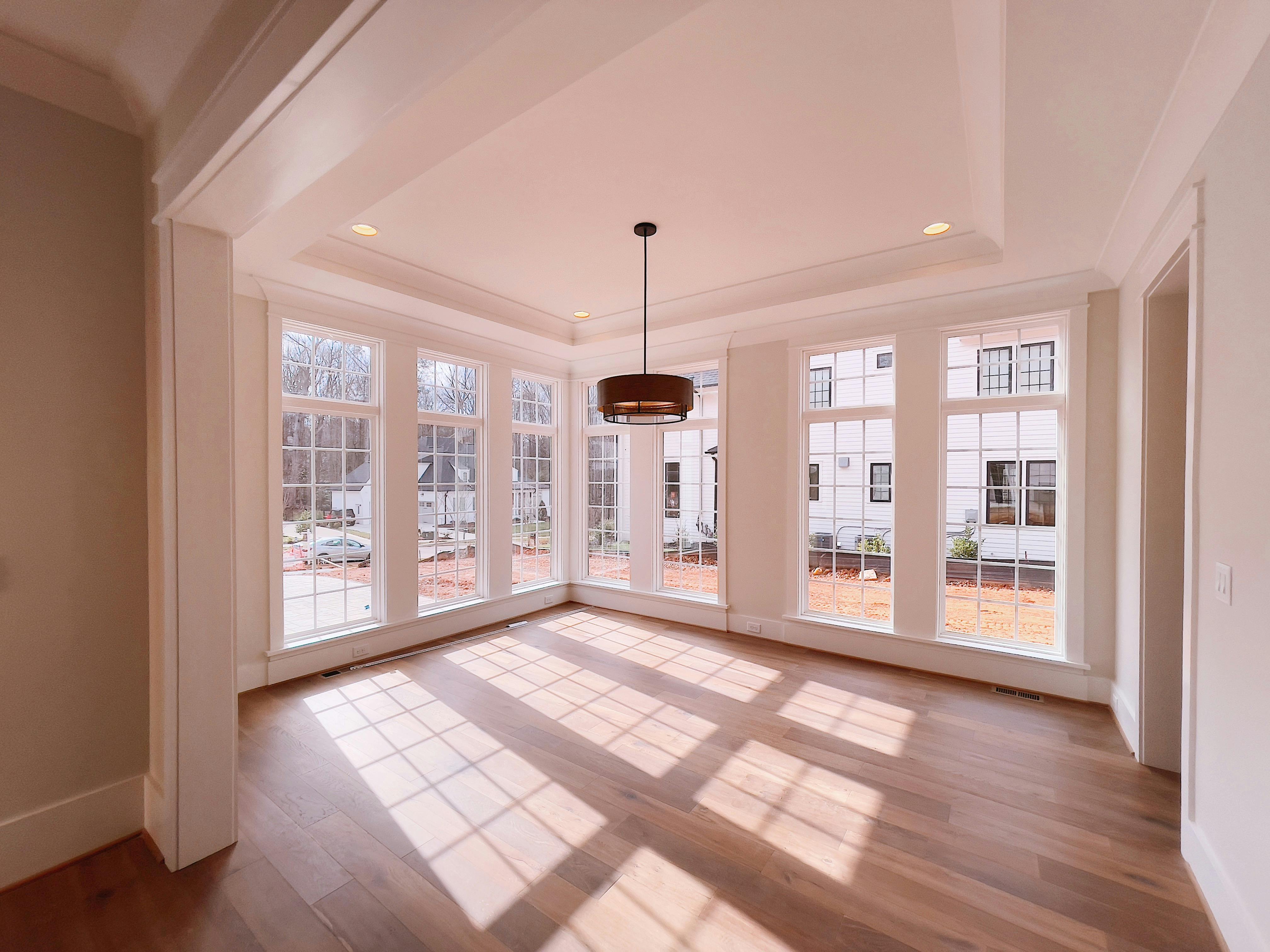 Light hardwood flooring in new construction bedroom