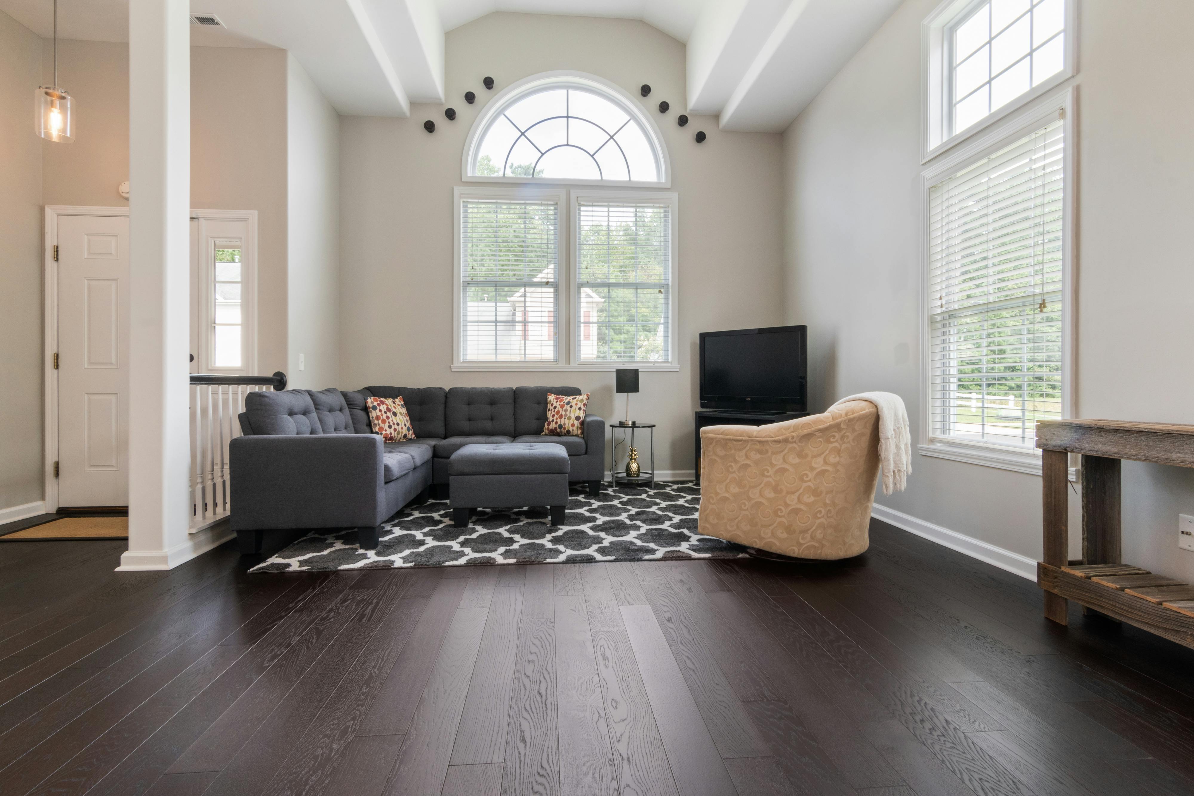 Dark wide plank flooring in living room with furniture
